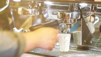 Close up coffee preparing in white ceramic cup from automatic coffee maker machine. video