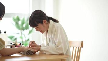 Image of a woman doing nails video