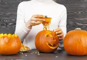 Woman cut out a pumpkin photo