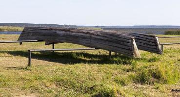 wooden boats are dried on the shore photo