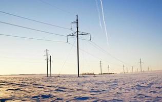 columns in the field - the electric columns which are standing in the field. winter. photo