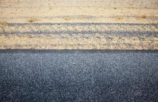 The edge of the asphalt road with the side of the road in asphalt, The side of the sand , top view photo