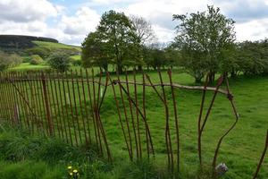 Broken Rod Iron Spike Fence Around a Field photo