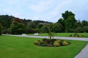 Stunning view of a private garden with white benches photo