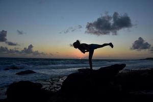 Yoga Warrior 3 Balance Pose with Setting Sun photo