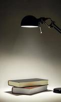 Sconce illuminating two books photo