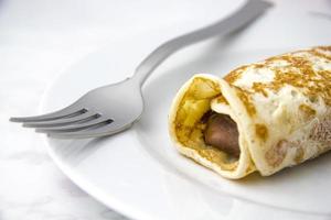 Crepe and fork on dish photo
