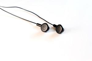 Black earphones on white photo