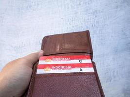 Surabaya, Jawa timur, Indonesia, 2022 - a man holds a wallet containing sim cards a and sim c of a vehicle photo
