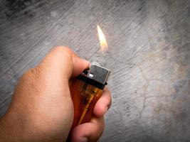 a man lights a gas lighter over low heat photo