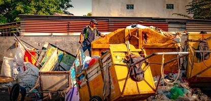 Gresik, Jawa timur, Indonesia, 2022 - a garbage man, janitor, garbage cart around the housing complex photo