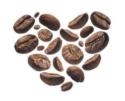 Coffee beans in the shape of a heart on a white background photo