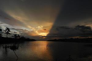 colorful dramatic sky with clouds at sunset. Sunset in  the lake photo