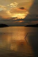 colorful dramatic sky with clouds at sunset. Sunset in  the lake photo