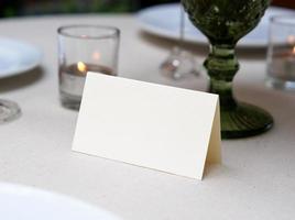 Mockup white blank space card on table setting with clipping path photo