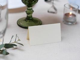 Mockup white blank space card on table setting with clipping path photo