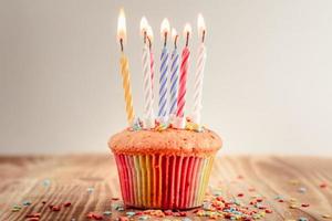 festive cupcake with lighted candles photo