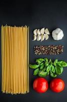 Pasta ingredients concept on black background photo