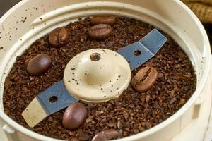 close up on an electric coffee grinder with coffee beans. shallow focus effect. soft focus. photo