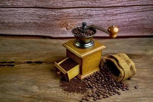 Vintage coffee grinder.Old retro hand-operated wooden and metal coffee grinder.Manual coffee grinder for grinding coffee beans. soft focus. photo