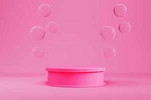 Pink cylindrical pedestal with flying glass spheres on light background for product display photo