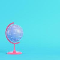 Pink chool globe on bright blue background in pastel colors photo