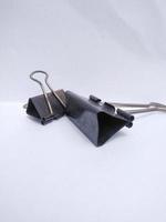 a paperclip that is often used in offices to clamp important documents photo