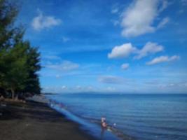 defocused abstract background of beach with clear blue sky on the island of Lombok, Indonesia photo