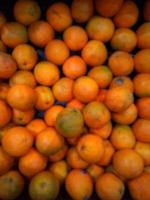 Defocused abstrack background of fresh fruits on display rack photo