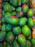 Defocused abstrack background of fresh fruits on display rack photo