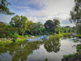 Defocused blur view of a parked boat at the riverbank in Lombok Island, Indonesia photo