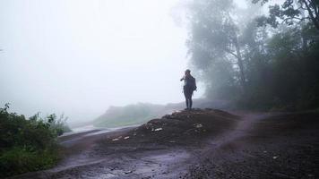 Girl walking traveling adventure nature in the rain forest. travel nature, Travel relax, Travel Thailand, rainy season. Phu Hin Rong Kla National Park photo