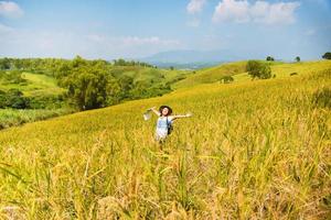 Asian women travel Rice fields green On the mountains in the holiday. happy and enjoying a beautiful nature. Rice fields Golden. Travel with a map of Asian girls. summer photo