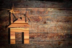 eco house  and a windmill on wood photo