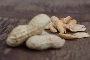 Peanuts in shells on wood background photo