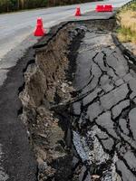 Cracked surface of an asphalt road photo