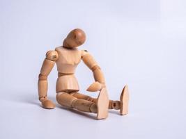 The wooden dummy sits on white background photo