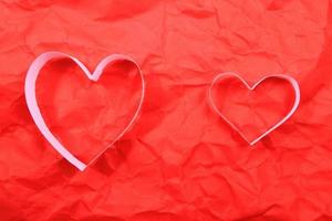 Paper hearts on red background photo