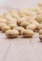 Soy beans on wood background photo