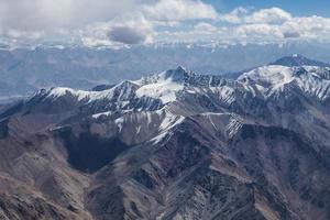 Himalaya mountains under clouds photo