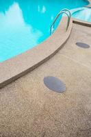 Swimming pool with stair at hotel close up photo