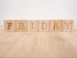 The word Friday on wooden cubes. Weekday business concept photo