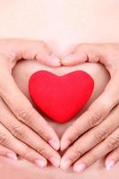 Female hands with red heart photo