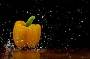 Yellow pepper in water stream photo