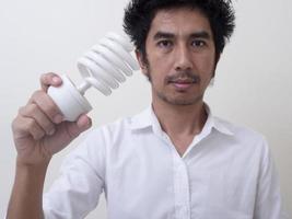 Man holding energy saving bulb for lamp photo