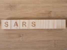 SARS word written on wood block photo