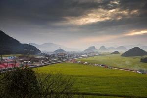 Yellow rapeseed flower field with the mist in Luoping, China photo