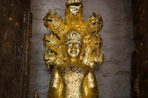 close up Buddha statue gilded in the measure photo