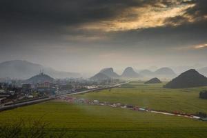 Yellow rapeseed flower field with the mist in Luoping, China photo