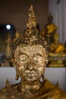 close up Buddha statue gilded in the measure photo